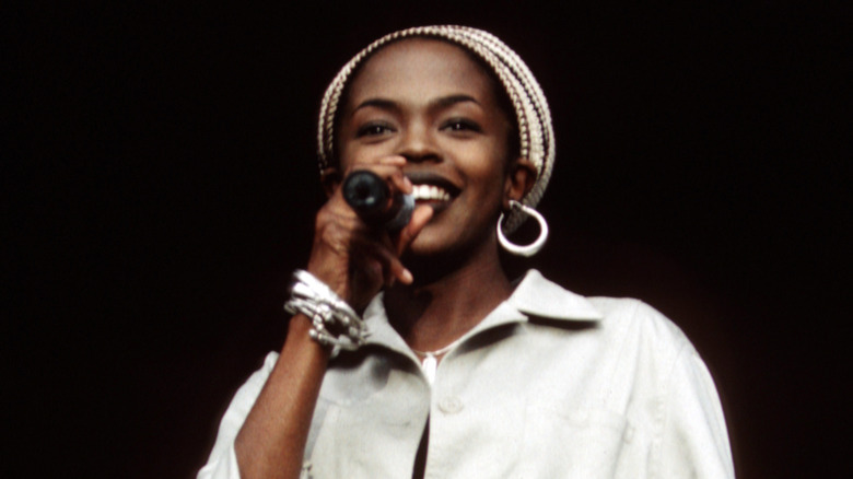 Lauryn Hill singing on stage and smiling in the '90s