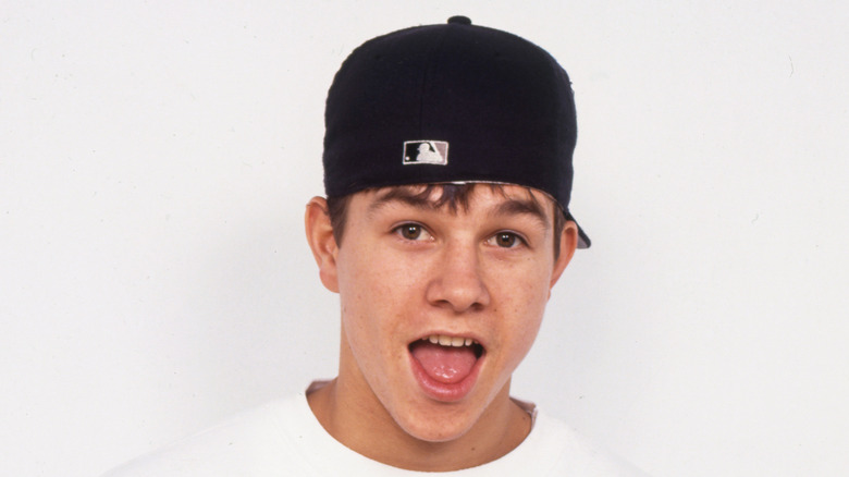 Mark Wahlberg in sideways cap and open mouth in early '90s