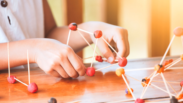 Child playing with model molecules