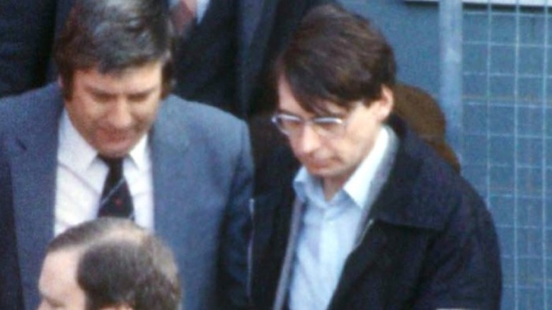 Dennis Nisen being escorted by police