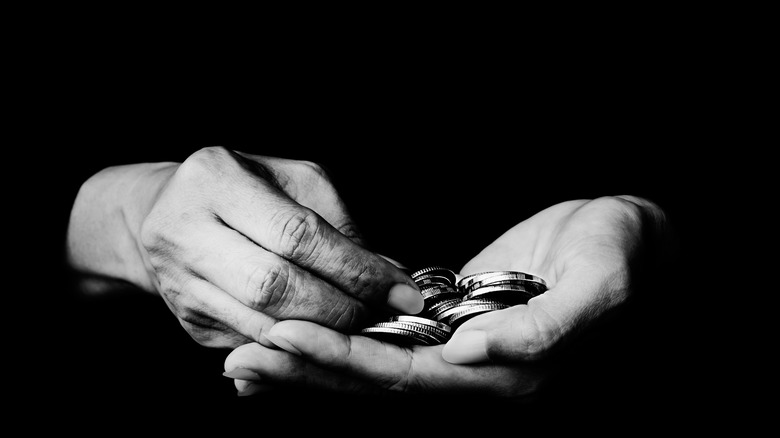 Hands holding coins