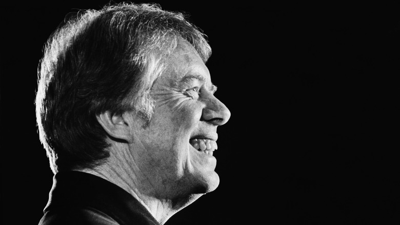 Jimmy Carter smiling to the right