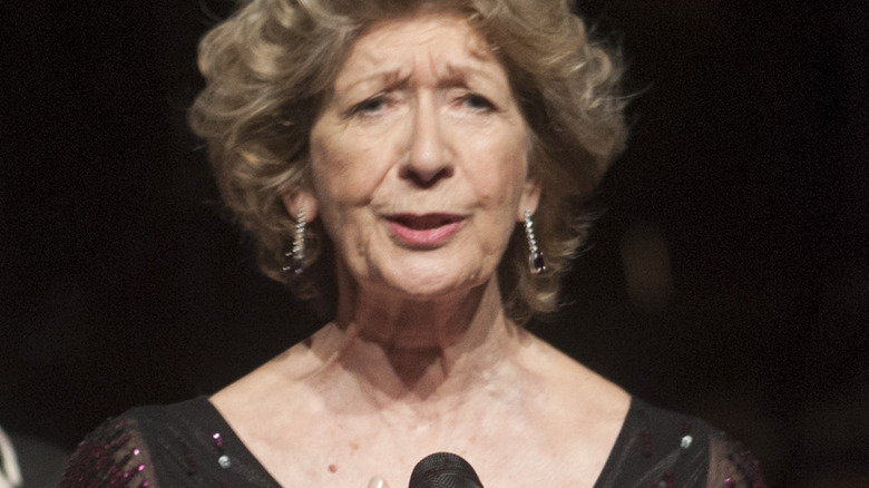 Felicity Lott stands at a microphone