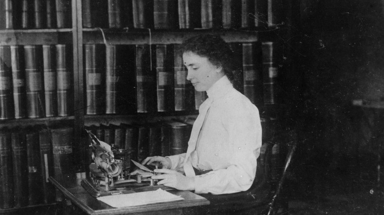 Helen Keller at a desk