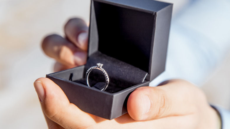 Engagement ring held in box