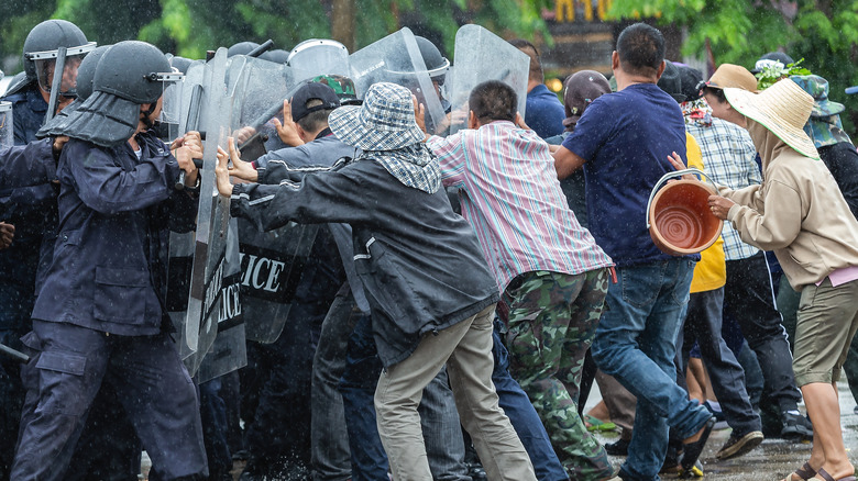 Police with shields clashing with protesters