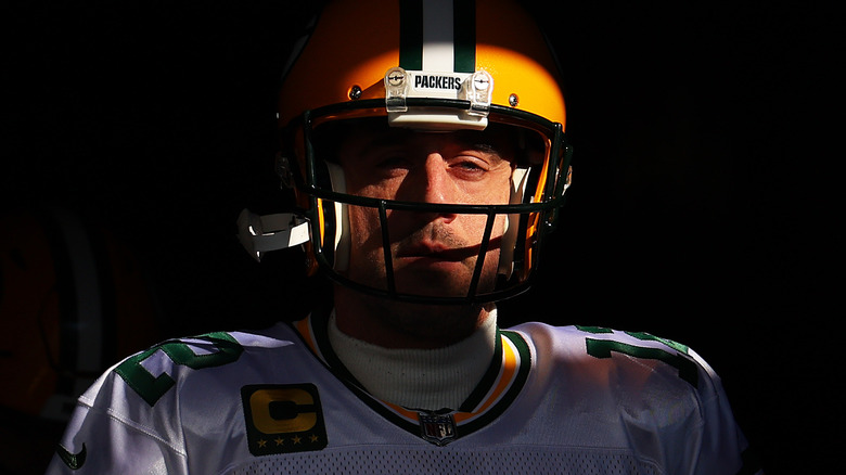 Aaron Rodgers grimacing in shadow