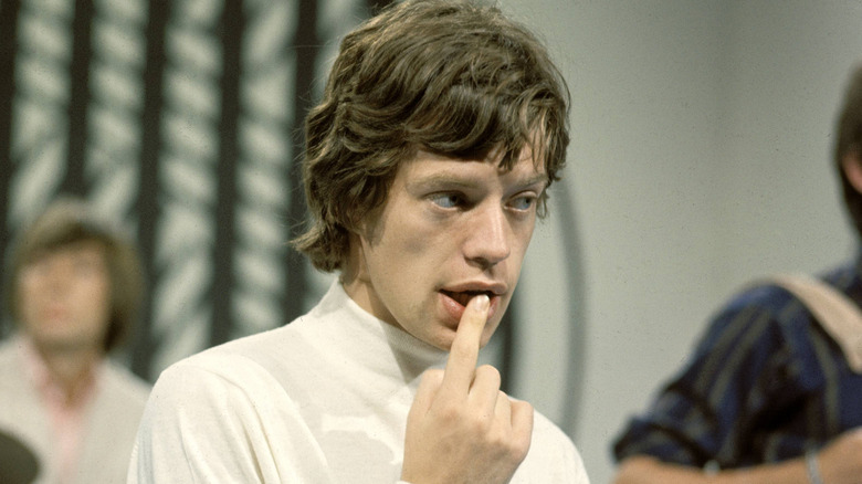 Mick Jagger with finger in mouth on TV in 1965