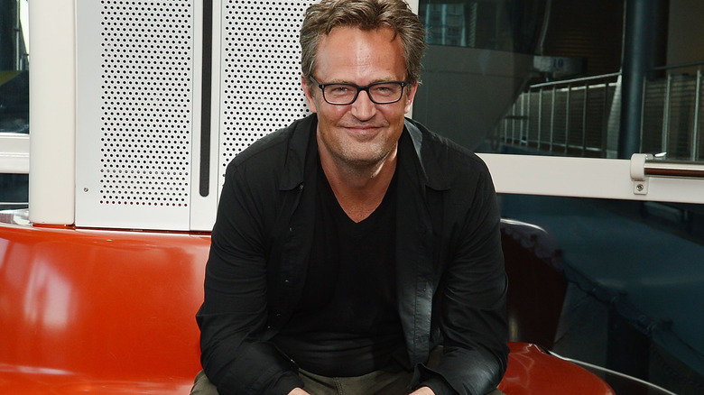 Matthew Perry glasses sat smiling