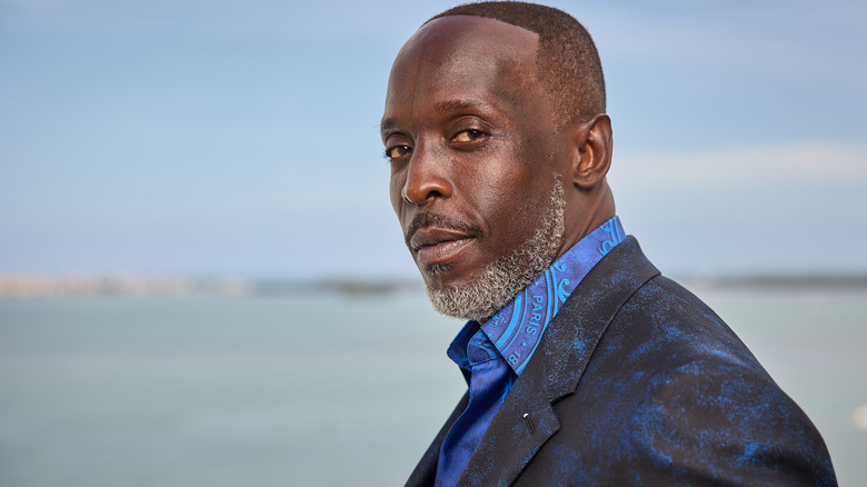 Michael K. Williams blue suit grey beard outside