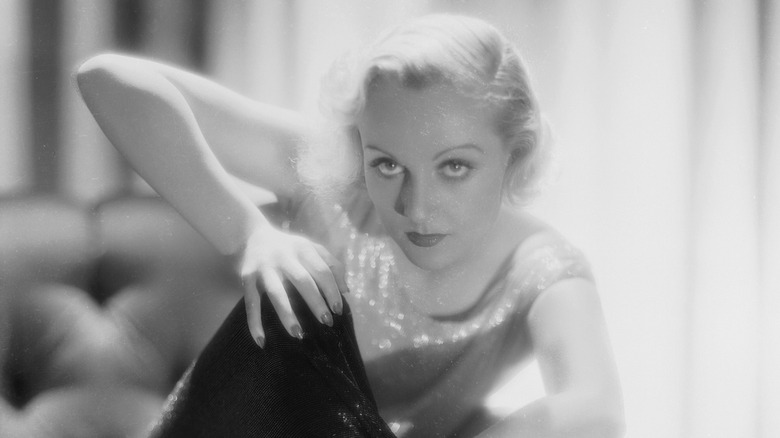 Carol Lombard posing on an armchair