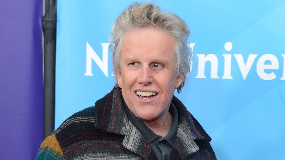 Gary Busey smiling colorful jacket at event