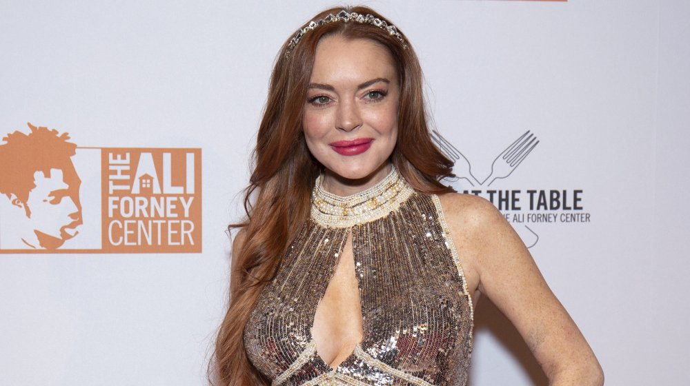 Lindsay Lohan smiling in glittery dress at event