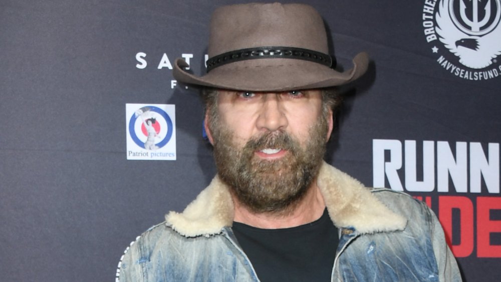 Nicolas Cage smiling with big beard and ranch hat