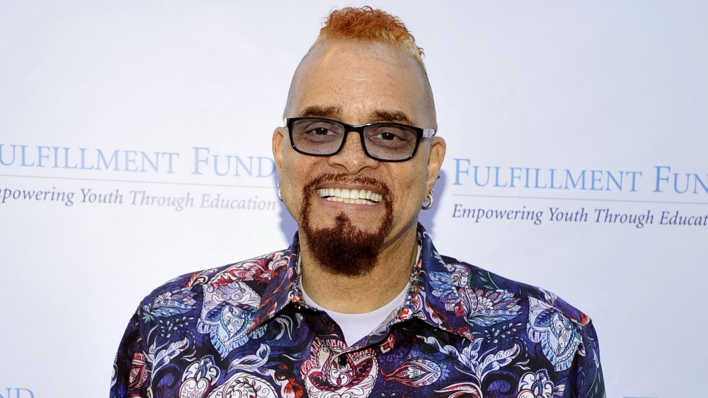 Sinbad smiling with glasses and floral shirt at event