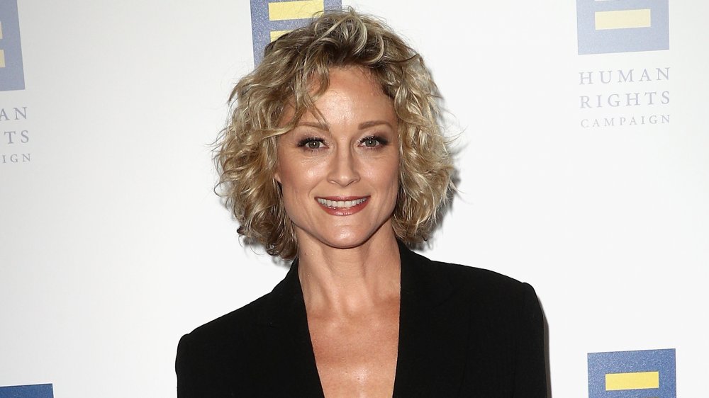 Teri Polo smiling in black jacket at event