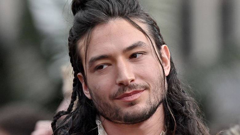 ezra miller cocked head smirking