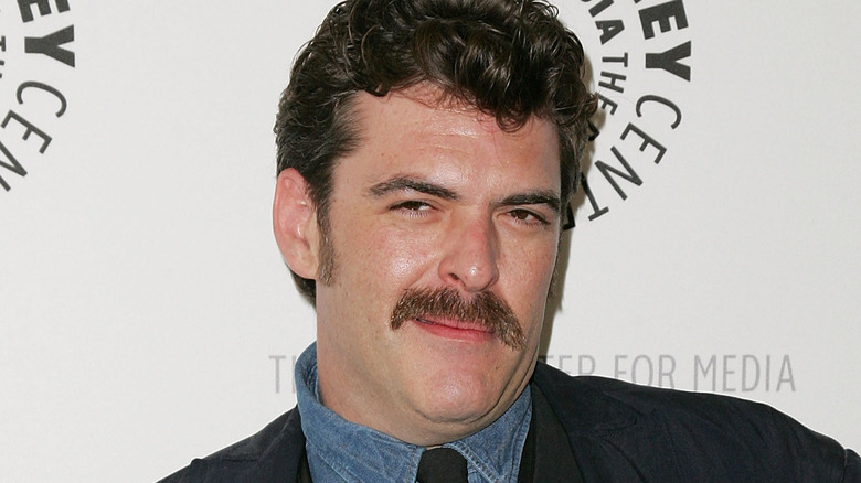 jay johnston with mustache smirking