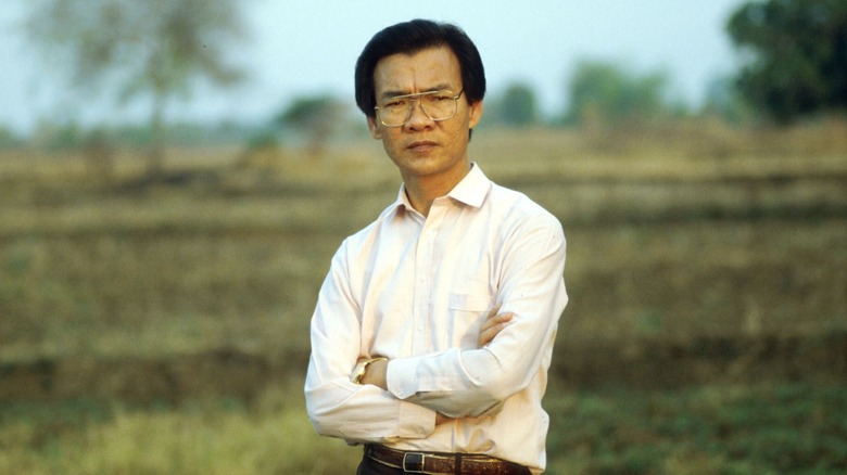 Haing Ngor standing in field
