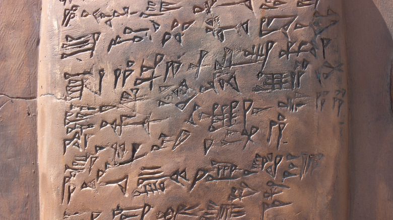 Akkadian cuneiform etching into tablet