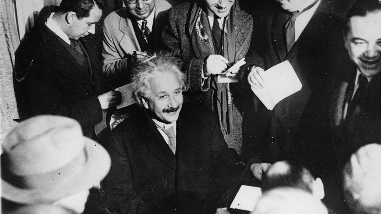Einstein surrounded by reporters
