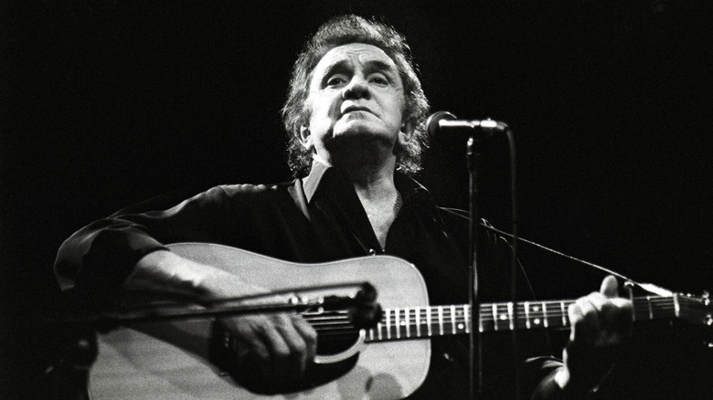 Johnny Cash sat playing guitar