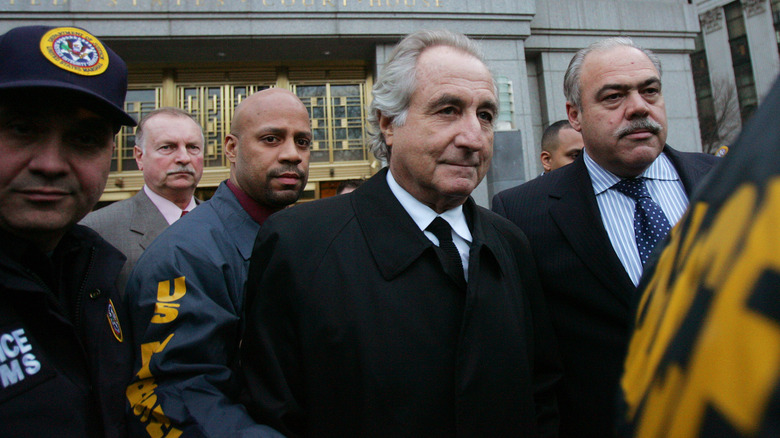 Bernie Madoff walks with police