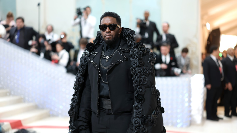 Sean Diddy Combs in black outfit on catwalk
