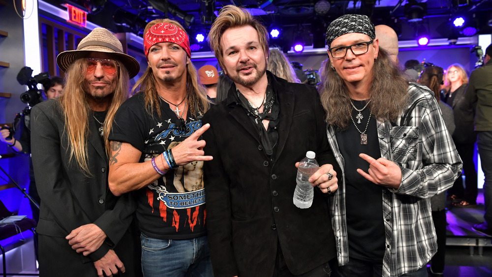 Poison members CC DeVille, Bret Michaels, RikkI Rockett, and Bobby Dall (L-R) pose at an event in 2019.