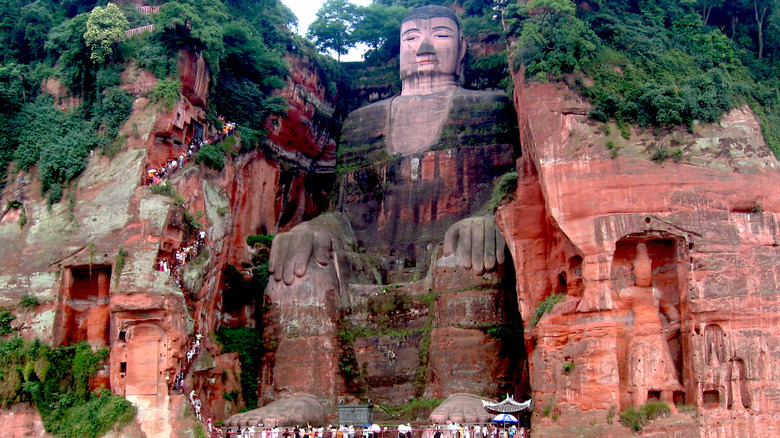 The giant Buddha statue sculpted from cliffs of red stone.