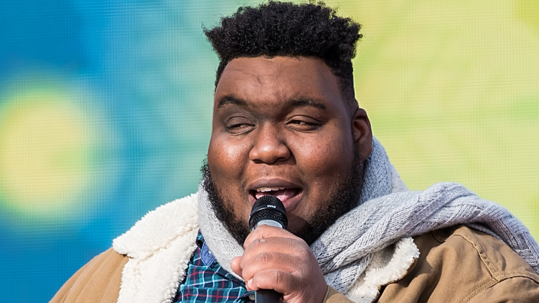 willie spence singing into microphone