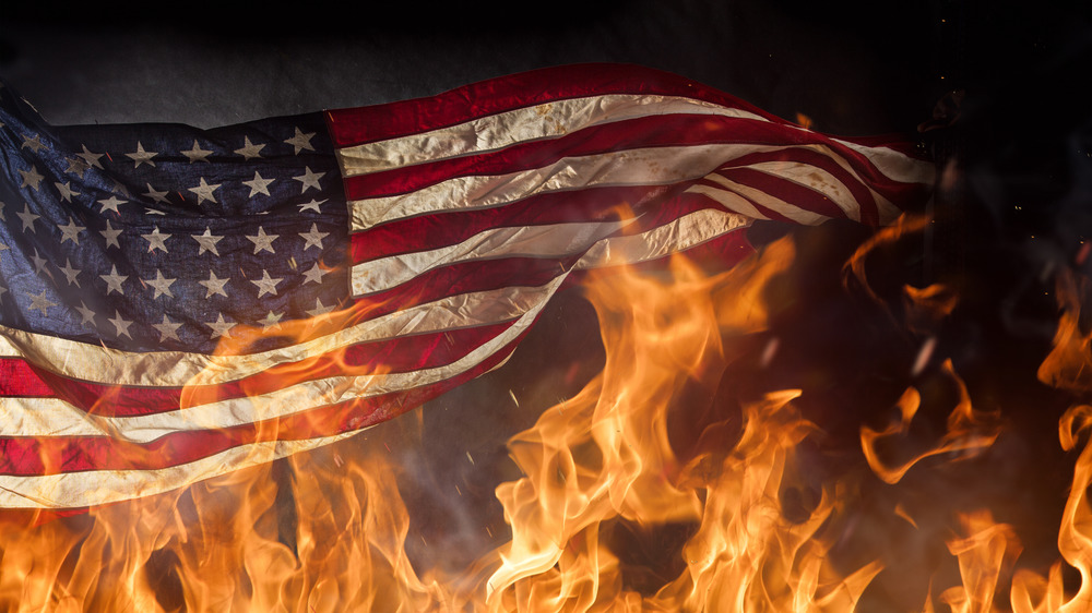 American flag above high flames