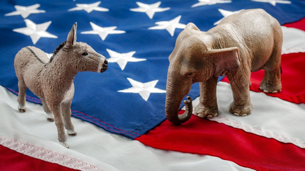Democratic donkey and GOP elephant on American flag.
