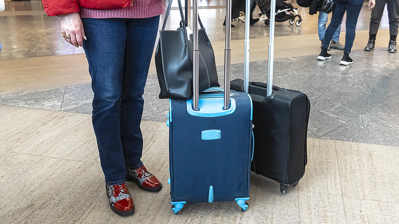 person evacuating with luggage