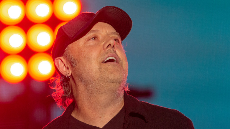 Lars Ulrich in cap looking up