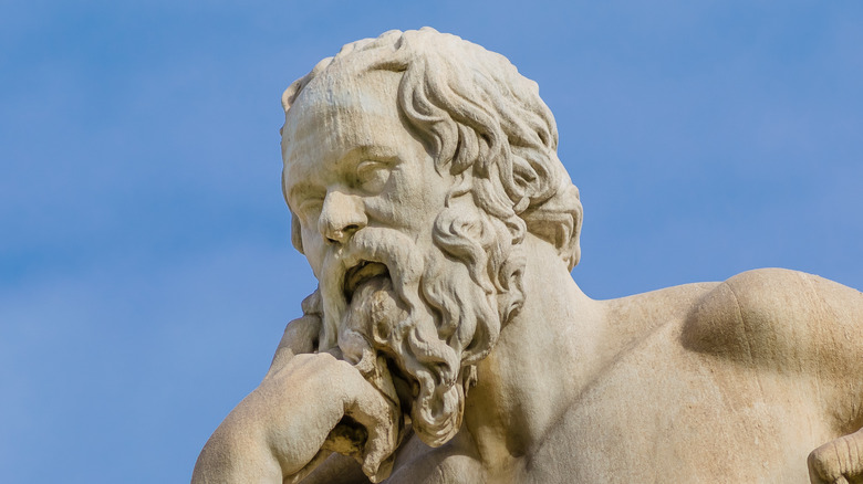 socrates thinking statue under blue sky