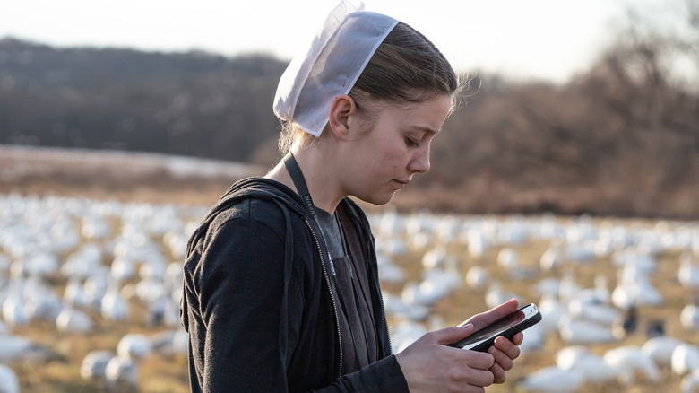 an amish woman using a cell phone