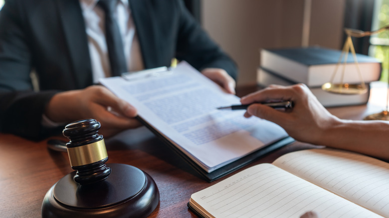 signing divorce papers with lawyer