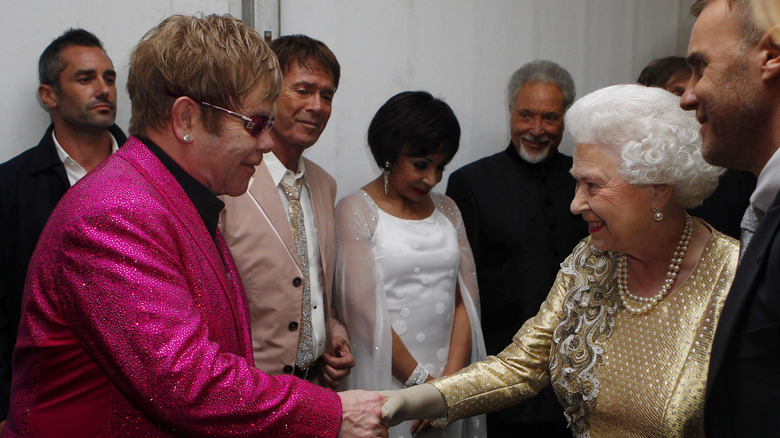 Elton John shaking hands Queen Elizabeth
