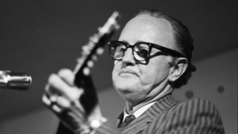 Bill Monroe performing in a suit
