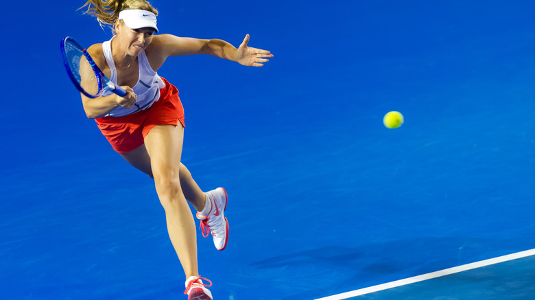 Maria Sharapova dives to hit the ball