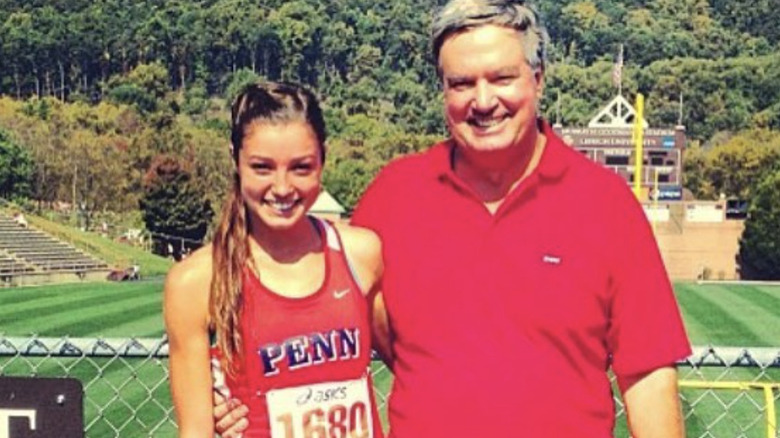 madison holleran red UPenn jersey embracing track coach