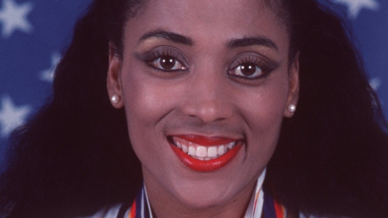 Florence Griffin Joyner smiling with medals