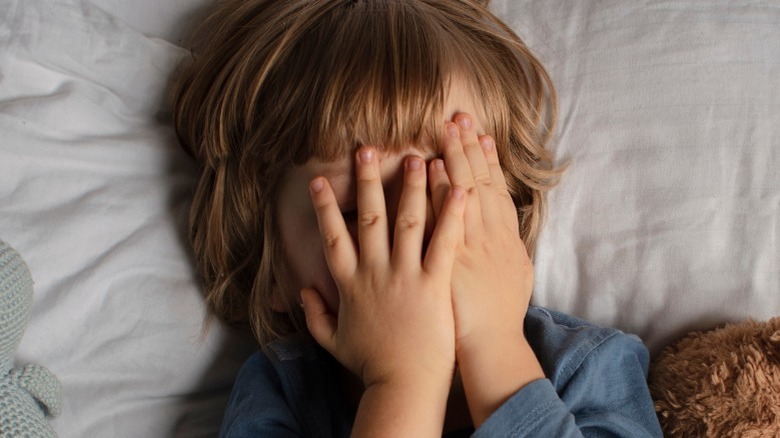 scared little boy in bed