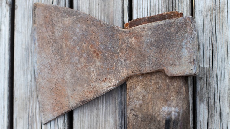 rusty ax with wood handle