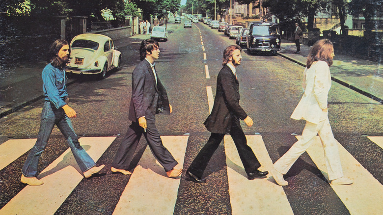 The Beatles walking across a crosswalk in album cover of Abbey Road