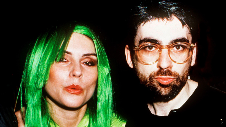 Debbie Harry with green hair and Chris Stein with beard and glasses