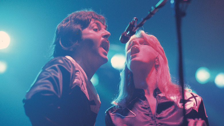 Paul McCartney and Linda McCartney singing together on stage
