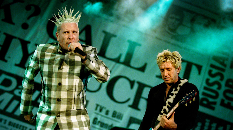 Singer Johnny Rotten (John Lydon) and guitarist Steve Jones performing, June 1996