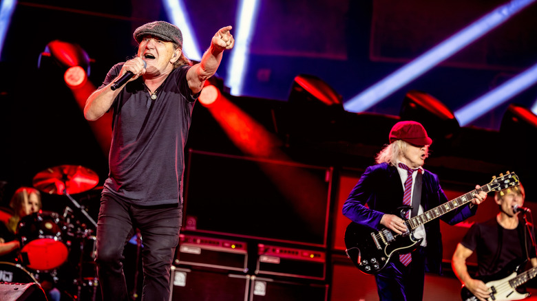 Brian Johnson and Angus Young of AC/DC performing on stage.